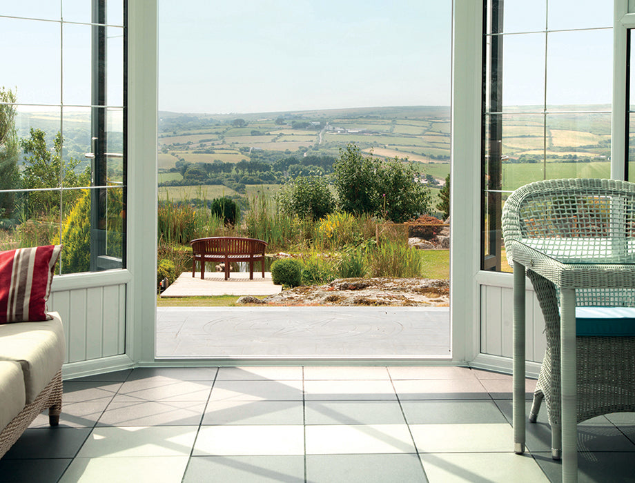 Large windows and open double doors offering a scenic view