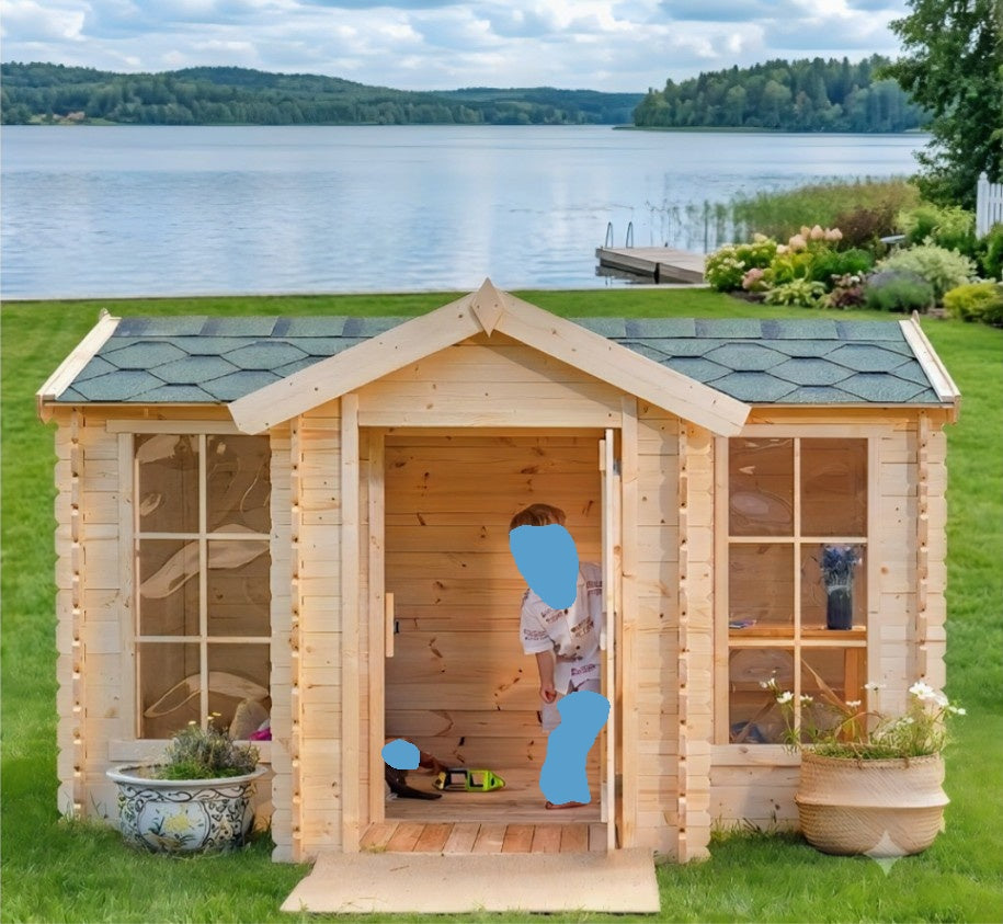 Allwood Isla playhouse set up outdoors near a sandbox
