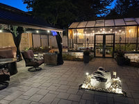 Janssens Royal Victorian greenhouse illuminated in an evening patio setting
