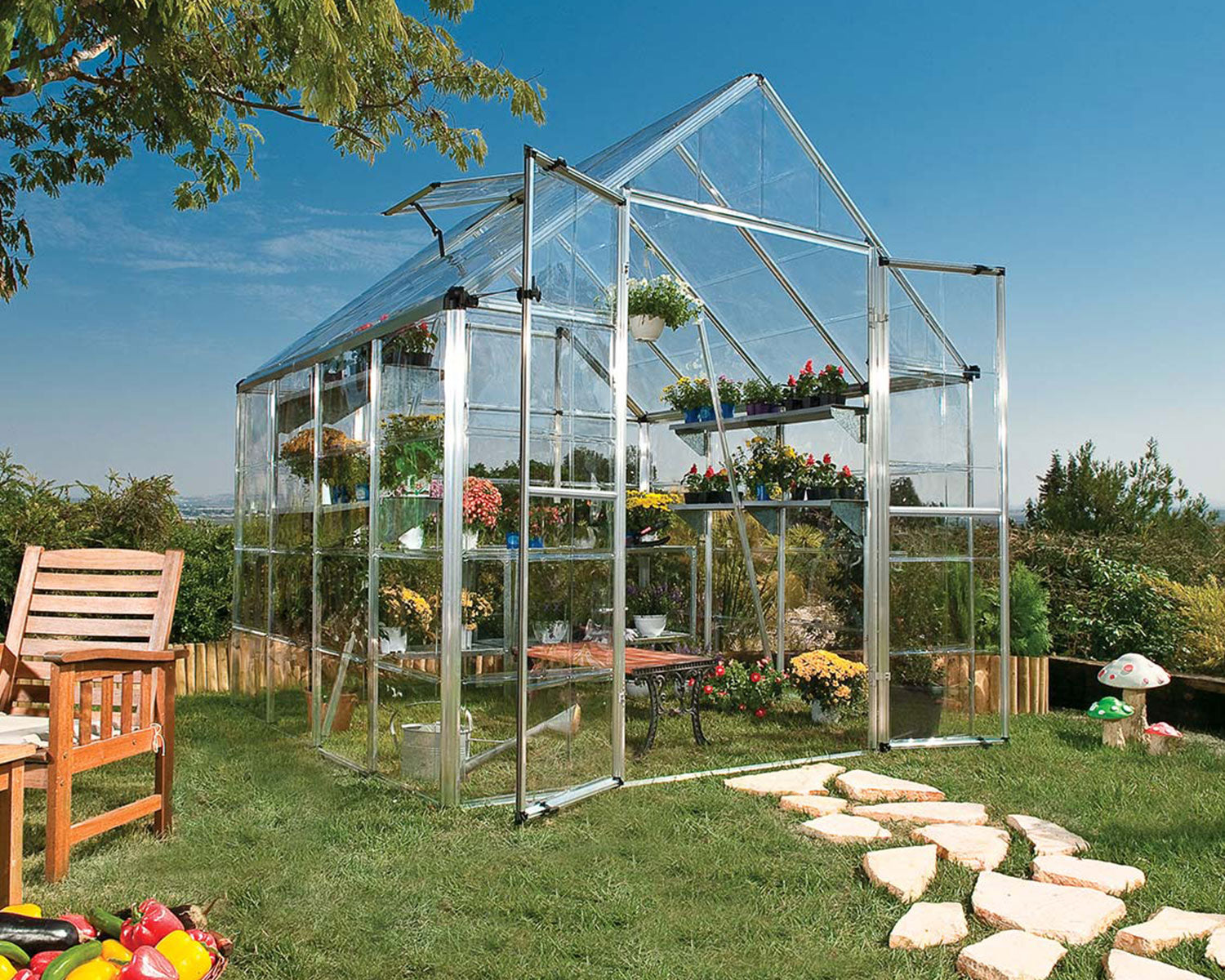 Snap & Grow 8ft greenhouse in a sunny garden setting, filled with plants