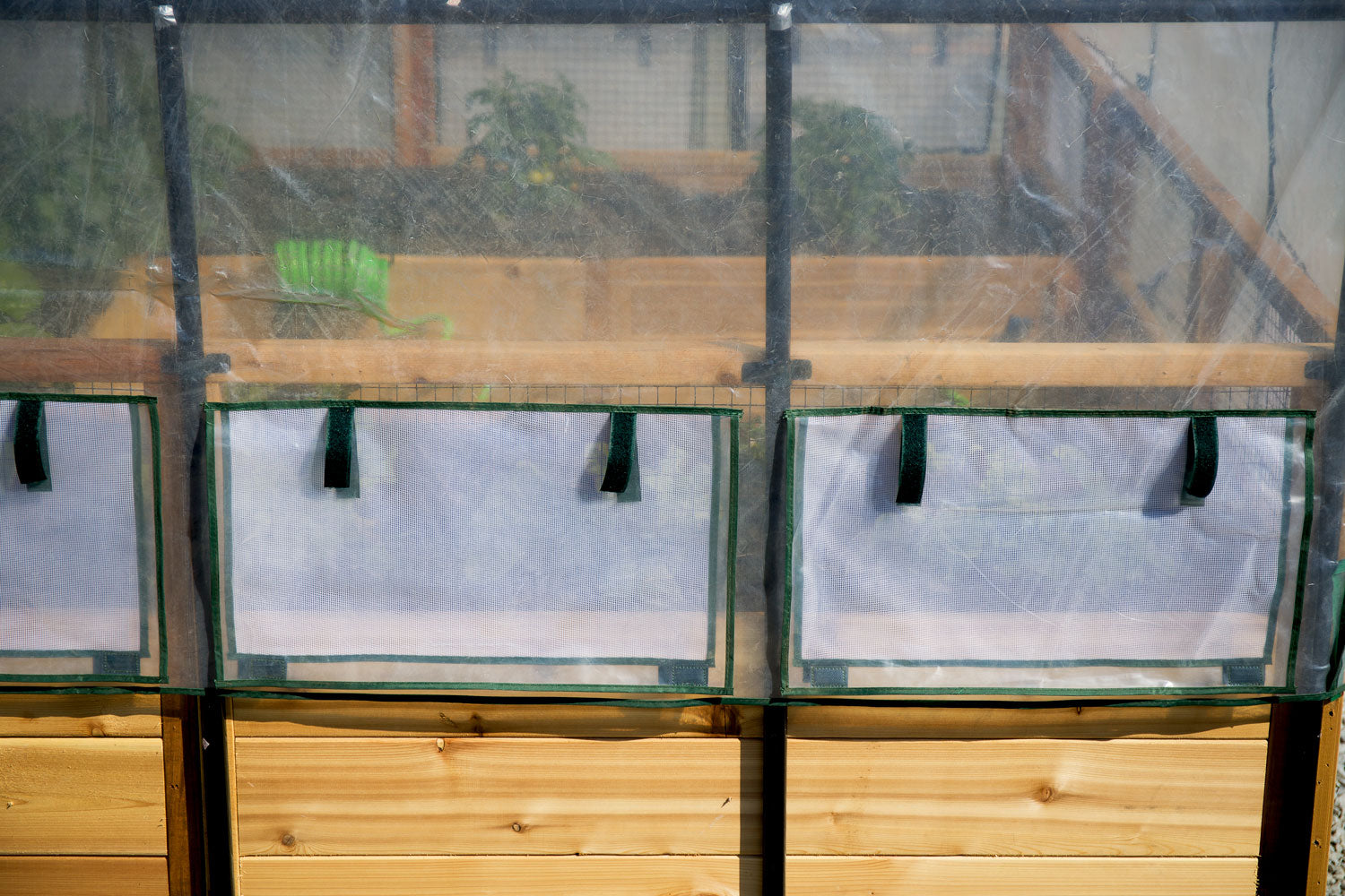 Raised garden bed with greenhouse cover, close-up view