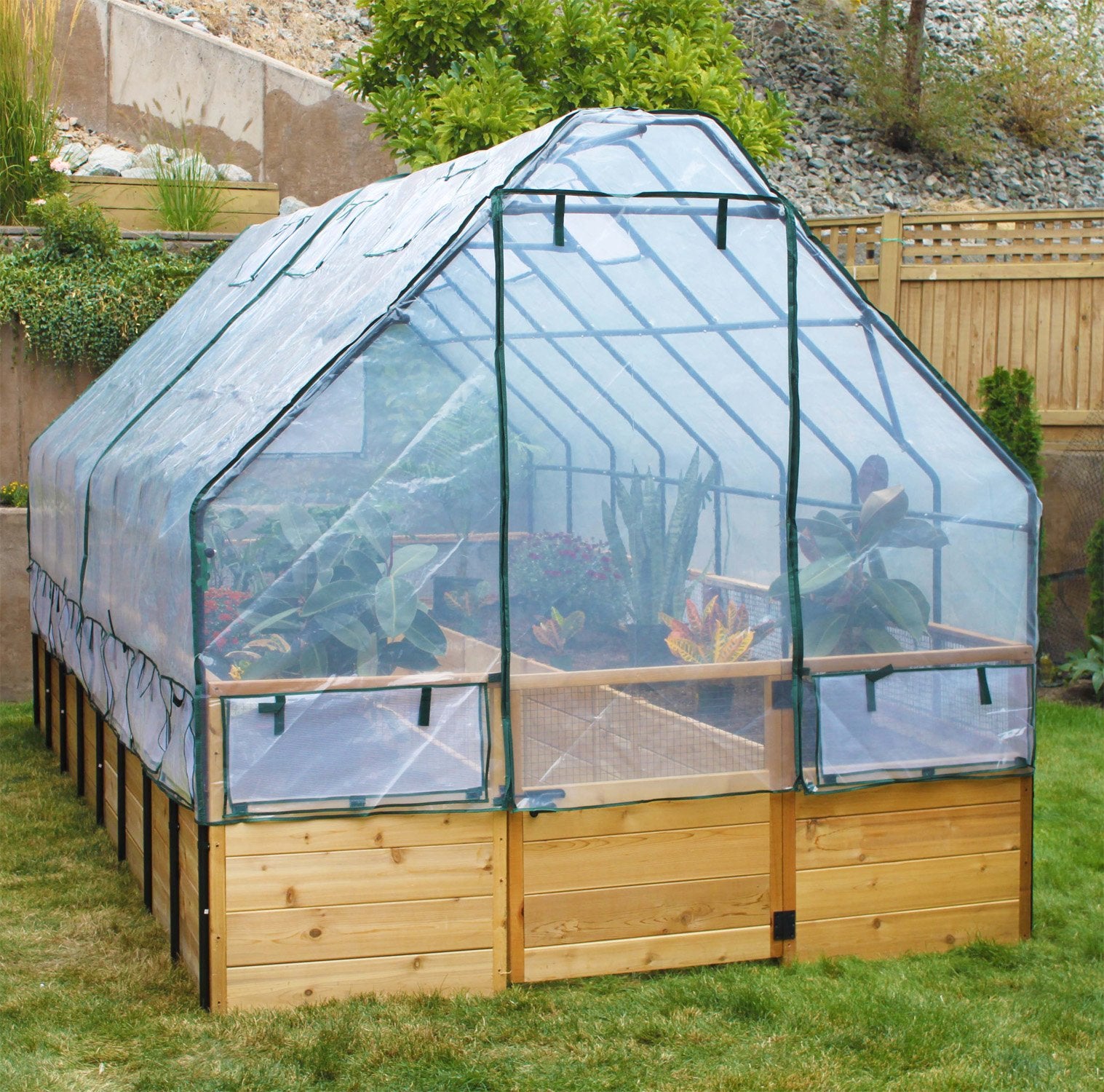 Raised cedar garden bed with greenhouse cover, close-up view