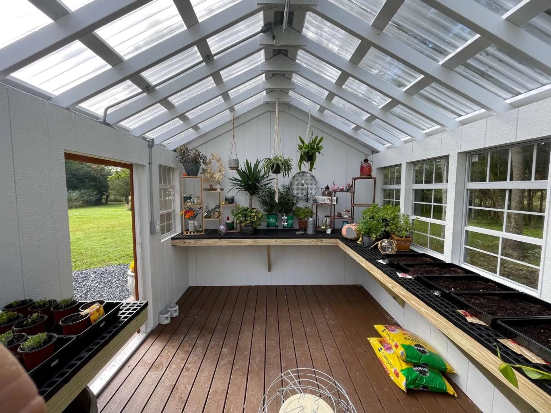 Finished white interior of cottage style greenhouse shed