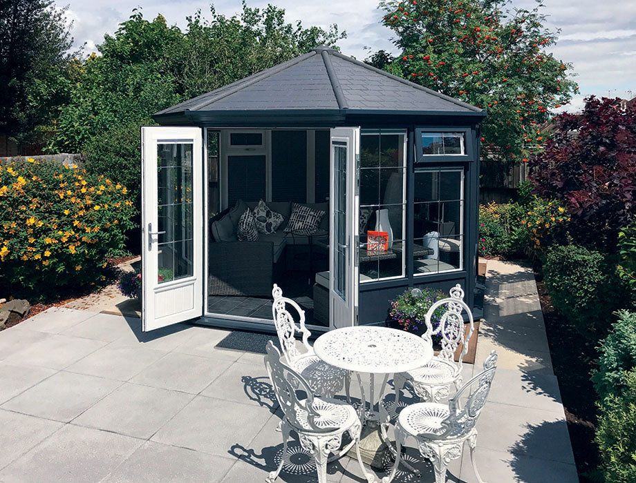 Garden room with black tile roof and white interior